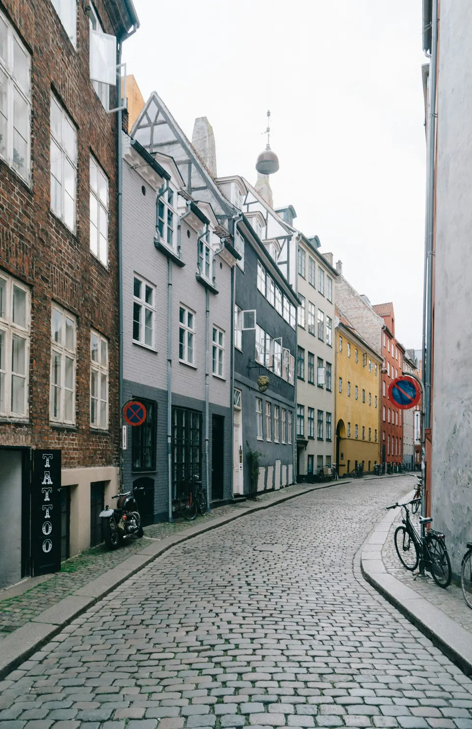 Bicycles along a quiet residential cobblestone street in Copenhagen