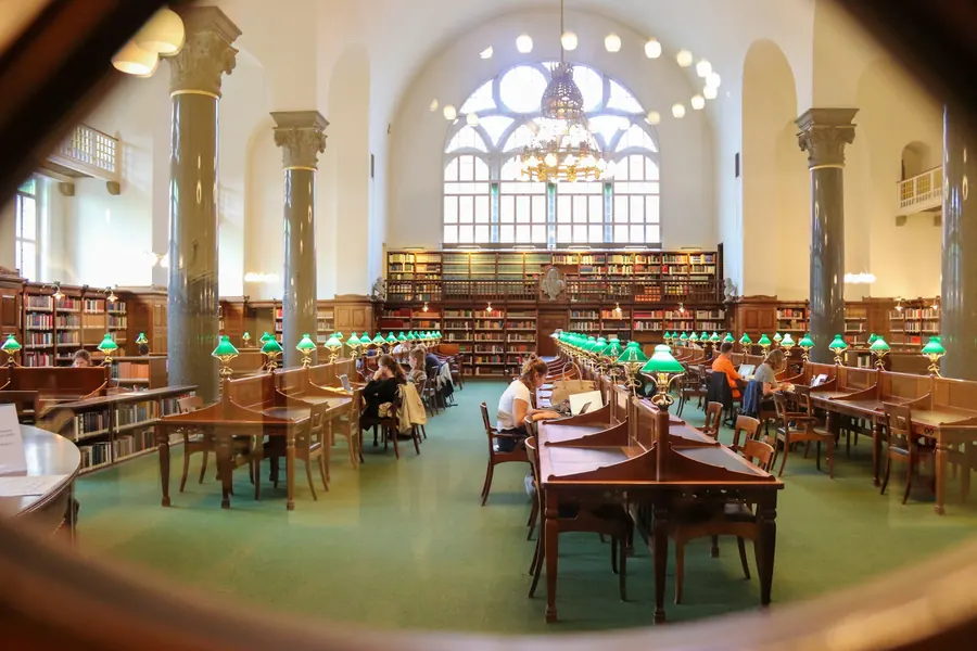 Readers working at timber desks in the Royal Danish Library reading room